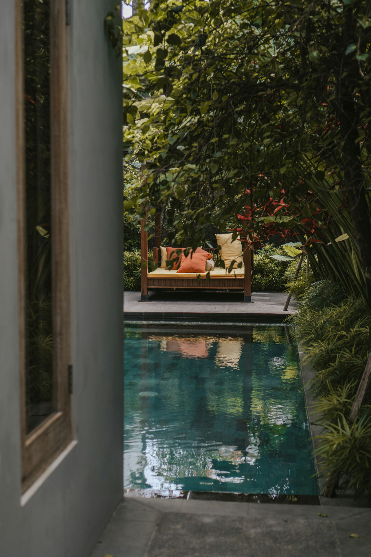 A serene private pool and daybed nestled in lush tropical gardens at a Bali resort